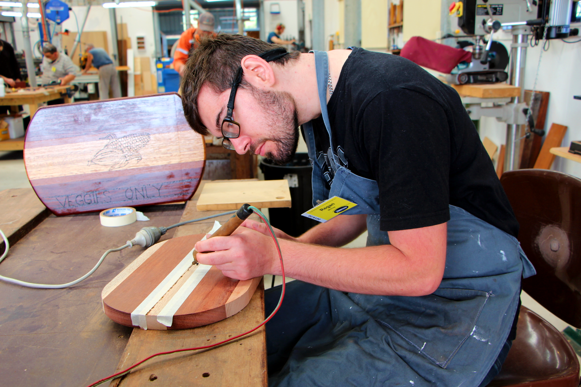 Regan creating chopping boards at the Men’s shed Regan creating chopping boards at the Men’s shed